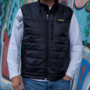 Person wearing a black Volt Heat quilted vest over a long sleeve white shirt