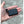 Volt Heat black rectangular rechargeable battery with attached charging cable held in palm