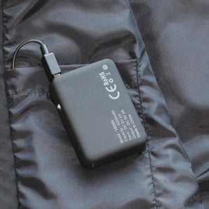 Volt Heat 6000mAh battery pack plugged into a black jacket pocket