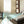 Vornado tower fan in a bedroom with graphic arrows illustrating airflow