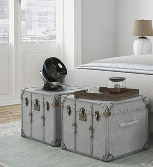 Vornado black air circulator fan on a grey vintage trunk bedside table