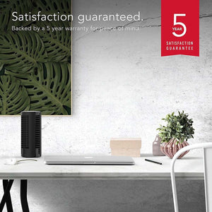 Vornado tower fan on a desk with a 5 year satisfaction guarantee badge