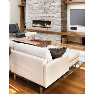 Vornado fireplace in a living room with white sofa and stone wall