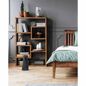 Vornado tower heater on wooden floor in bedroom next to wooden bookshelf