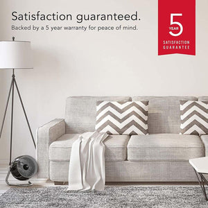 Vornado fan in living room with 5 year satisfaction guarantee graphic