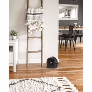 Black Vornado space heater on a wooden floor in a living room