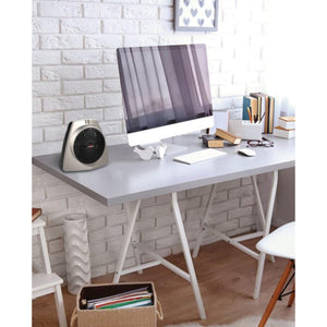 Vornado personal space heater on a desk next to a computer monitor