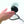 Hand held near a black Vornado Zippi personal fan