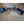 Mattress Cooler portable cooling units with blue pads and a folded grey mattress topper on tiled floor