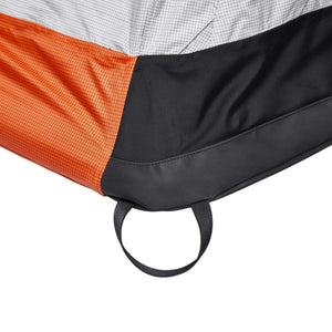 Black Diamond tent corner detail showing orange and grey ripstop fabric with black mesh and webbing loop