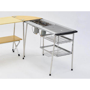 Snow Peak modular camping kitchen table with integrated stove and wire storage baskets