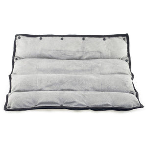 Grey plush rectangular heating pad with black trim and snap buttons