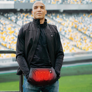 Man wearing a black ActionHeat heated vest with visible heating element in the front pocket