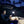 Man charging a smartphone with a Wagan lantern inside a tent at night