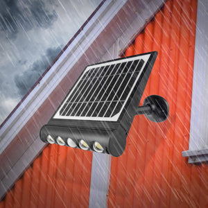 Wagan solar powered LED wall light mounted on an orange exterior wall during rain