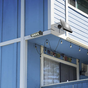 Wagan solar light mounted on the exterior wall of a blue house