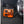 Portable orange and black jump starter and air compressor connected to a car tire