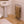 WarmRails chrome floor standing towel warmer with tan towels in a bathroom