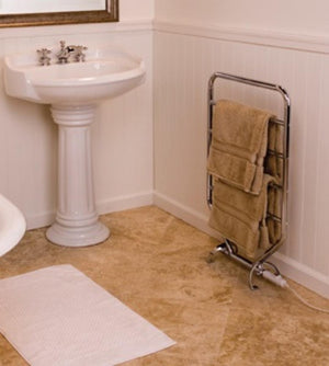 WarmRails chrome floor standing towel warmer with tan towels in a bathroom