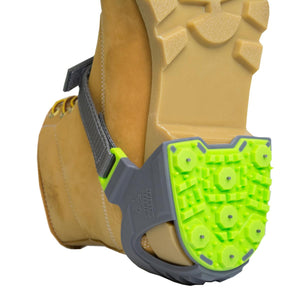 Winter Walking ice cleat attached to the heel of a tan work boot