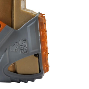 Winter Walking ice cleat attached to a tan boot sole
