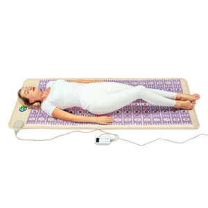 Woman lying on a HealthyLine amethyst gemstone heating mat with a digital controller