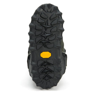 Neos boot tread showing black rubber lugged sole with yellow Vibram logo
