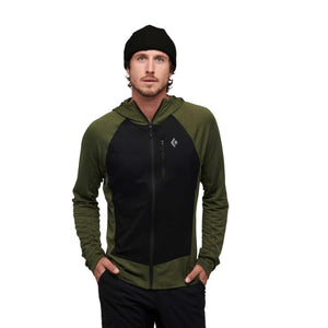 Man wearing a Black Diamond olive green and black zip up hooded jacket with a black beanie