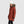 Woman wearing an Outdoor Research rust colored puffer parka with a faux fur hood and white beanie