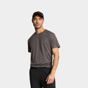 Man wearing a grey Mission t-shirt and a black baseball cap