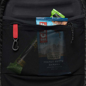 Black Diamond backpack mesh pocket containing energy bars and a carabiner