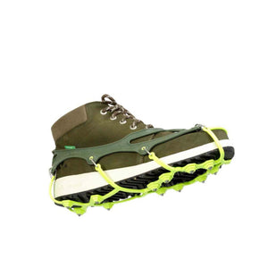 Snowline traction spikes attached to an olive green hiking boot
