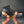 Winter Walking ice cleats with orange straps attached to a black work boot