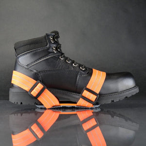 Winter Walking ice cleats with orange straps attached to a black work boot