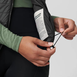 Hands adjusting the internal drawcord of a FjallRaven jacket