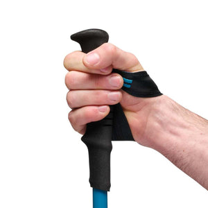 Hand gripping a Black Diamond trekking pole with foam handle and wrist strap