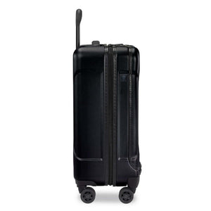 Side view of a black Briggs and Riley hard shell carry on suitcase with four wheels and an extended handle
