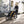 Woman jogging on a paved path pushing a yellow and black Thule child carrier