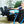 Woman wearing a black cold therapy wrap on her foot while sitting in a recliner