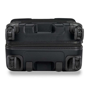 Bottom view of a black Briggs and Riley hard shell suitcase showing four spinner wheels