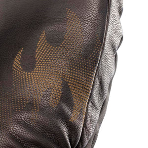 Close up of brown textured leather with a perforated dot pattern graphic