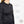Black heated jacket showing breathable fabric moisture wicking mesh and battery pockets with Belgian and German technology