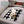 Zone Tech black and white plaid polar fleece pet mat on a car seat with a small dog lying on it