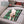 Zone Tech green plaid polar fleece pet heating pad on a car seat with a small dog lying on it