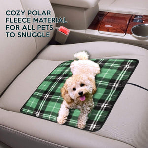 Zone Tech green plaid polar fleece pet heating pad on a car seat with a small dog lying on it