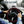 Driver holding a Zonetech steering wheel cover in a car during winter