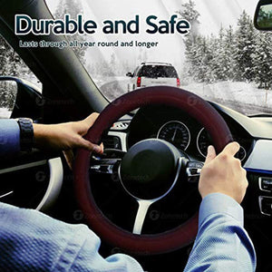 Driver holding a Zonetech steering wheel cover in a car during winter