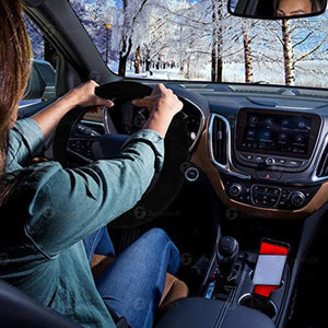 Person driving a car with a Zonetech steering wheel cover in a snowy landscape